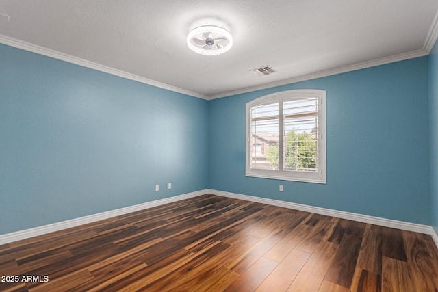 spare room with baseboards, dark wood finished floors, and crown molding