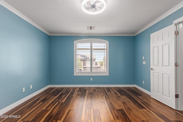 empty room featuring baseboards, wood finished floors, and ornamental molding