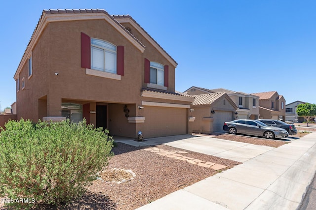 view of front of house featuring stucco siding, concrete driveway, an attached garage, and a tile roof