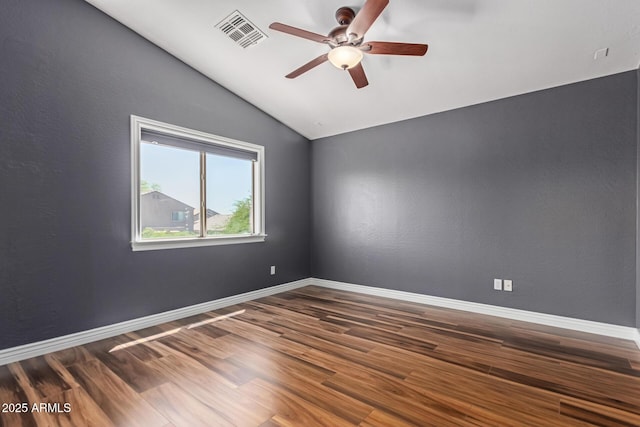 empty room featuring lofted ceiling, a ceiling fan, wood finished floors, and baseboards