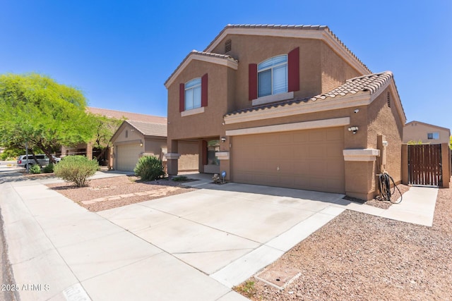 view of front facade featuring a tile roof, stucco siding, concrete driveway, and a garage