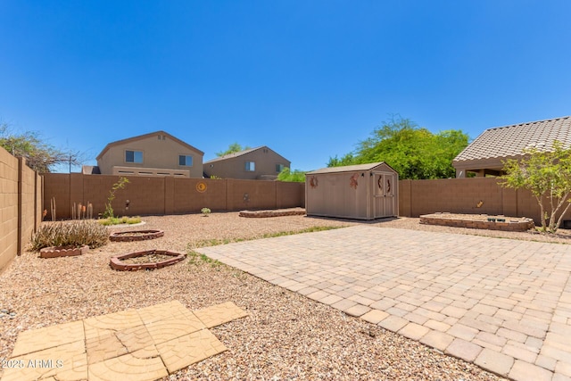 fenced backyard with a patio, a storage unit, and an outdoor structure