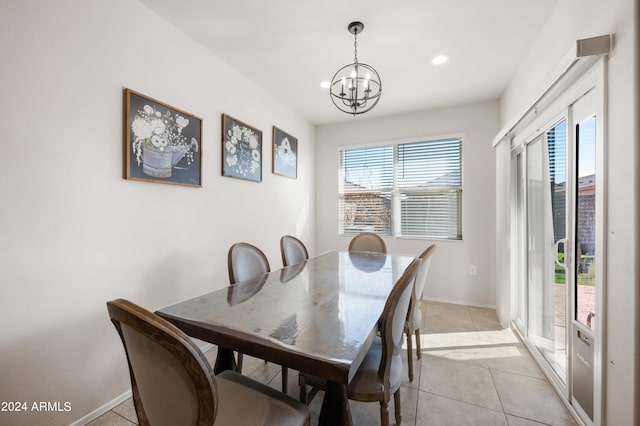 tiled dining room featuring a chandelier