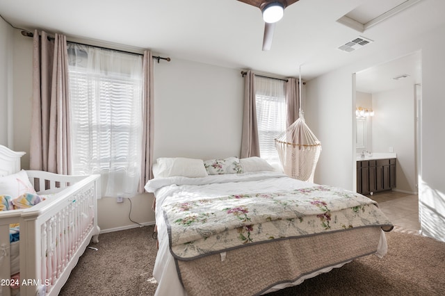 carpeted bedroom with ceiling fan and connected bathroom