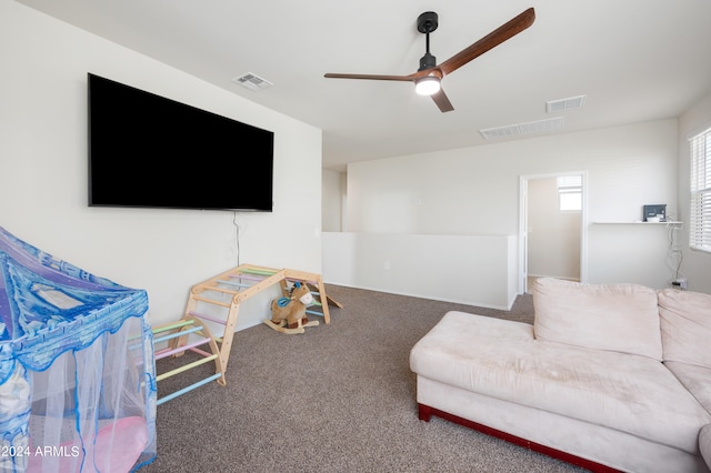 living room featuring ceiling fan and carpet floors