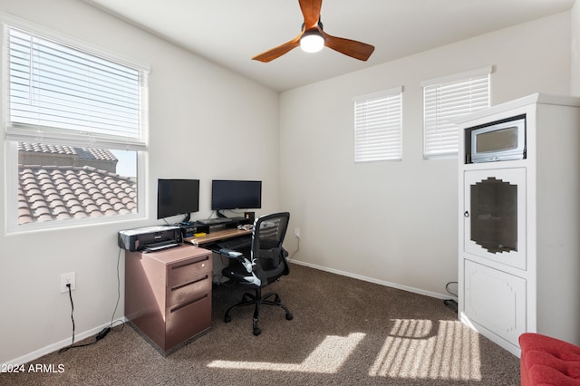 office area with dark colored carpet and ceiling fan