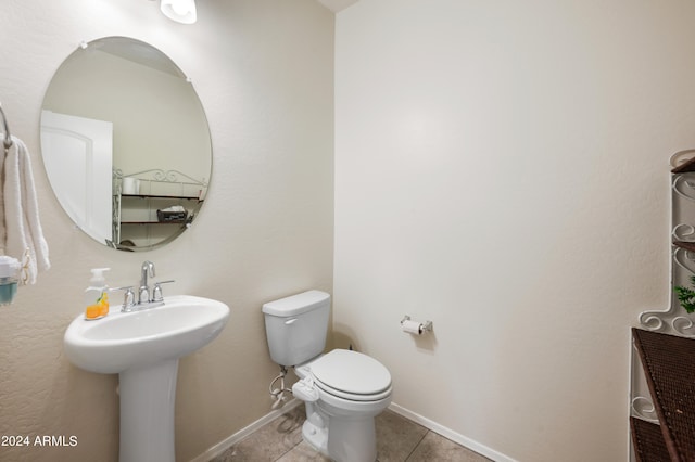 bathroom with sink, toilet, and tile patterned floors