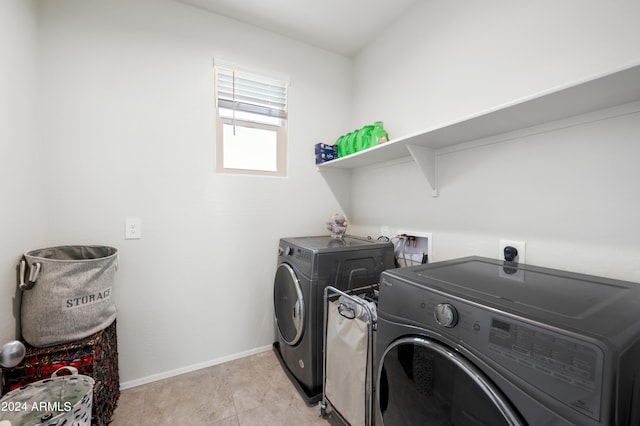 washroom featuring independent washer and dryer and light tile patterned floors