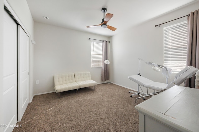 office area with dark colored carpet and ceiling fan