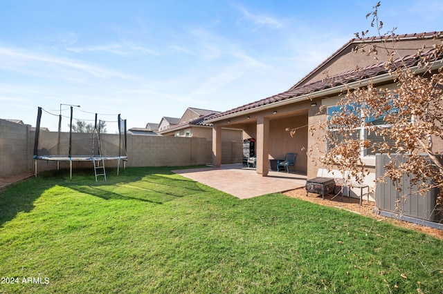 view of yard with a patio and a trampoline