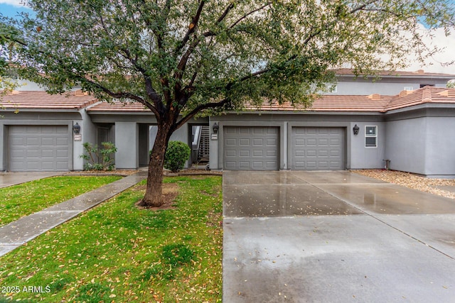 7401 W Arrowhead Clubhouse Dr Unit 1006, Glendale, AZ 85308 - townhome / multi-family property featuring concrete driveway, a front lawn, a tile roof, and stucco siding