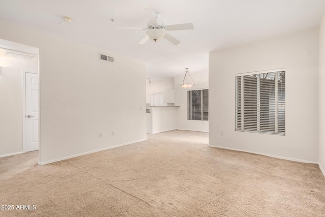 7401 W Arrowhead Clubhouse Dr Unit 1006, Glendale, AZ 85308 - unfurnished living room featuring baseboards, light colored carpet, visible vents, and ceiling fan