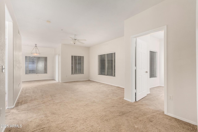 7401 W Arrowhead Clubhouse Dr Unit 1006, Glendale, AZ 85308 - unfurnished living room with baseboards, a ceiling fan, and carpet floors