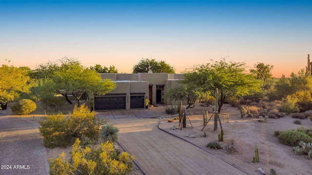 pueblo-style house with a garage