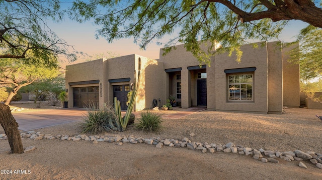 southwest-style home with a garage