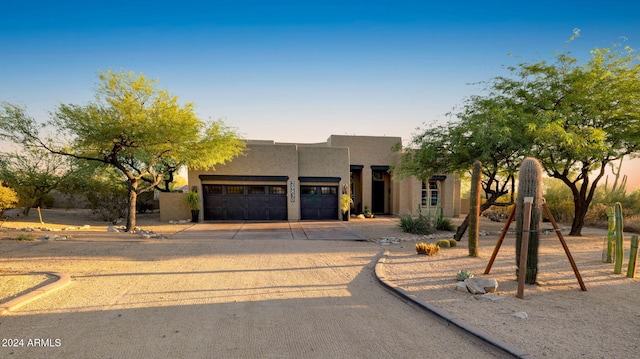 southwest-style home with a garage