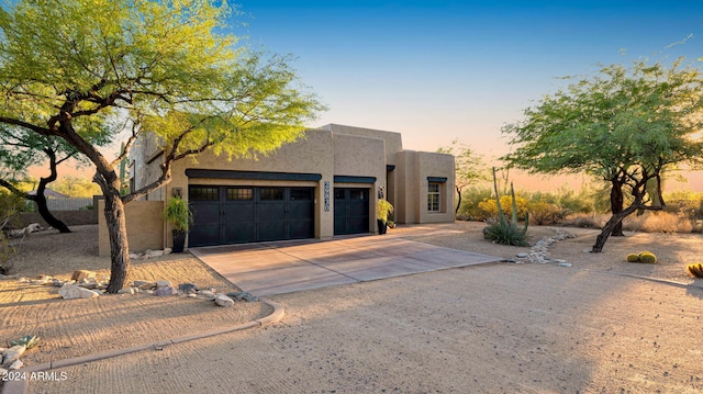 pueblo-style home with a garage