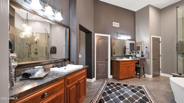 bathroom featuring tile patterned flooring, shower with separate bathtub, vanity, and a towering ceiling