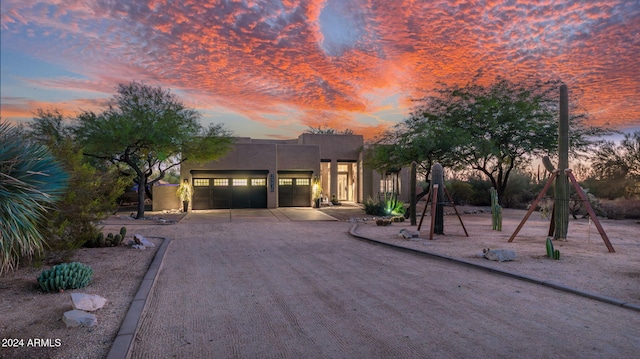 pueblo-style house featuring a garage