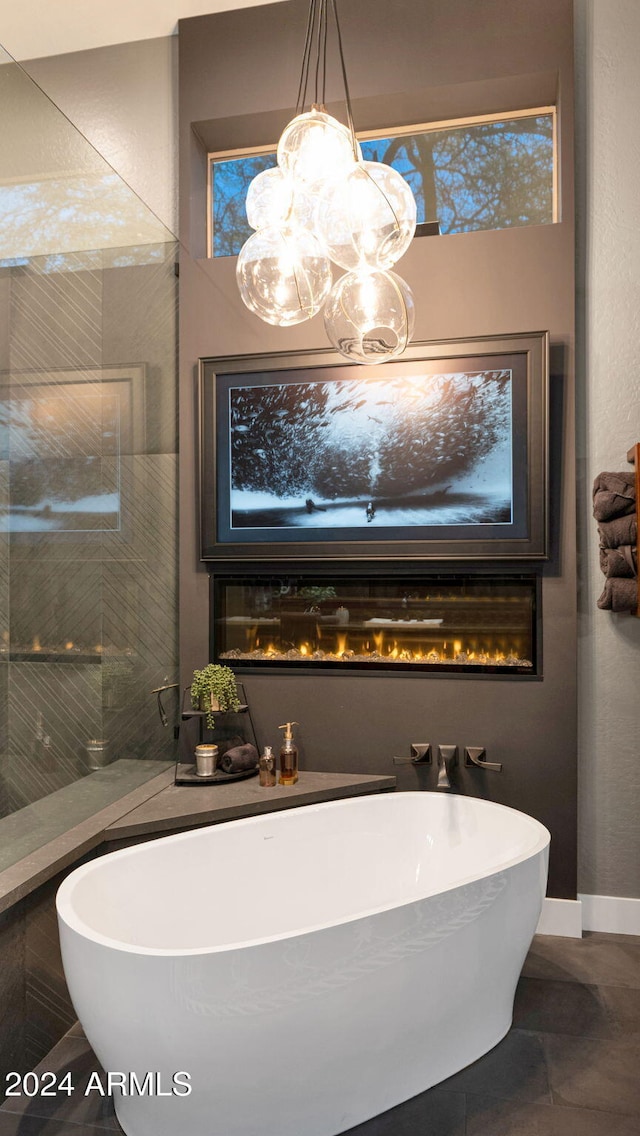 bathroom with a washtub and tile patterned flooring