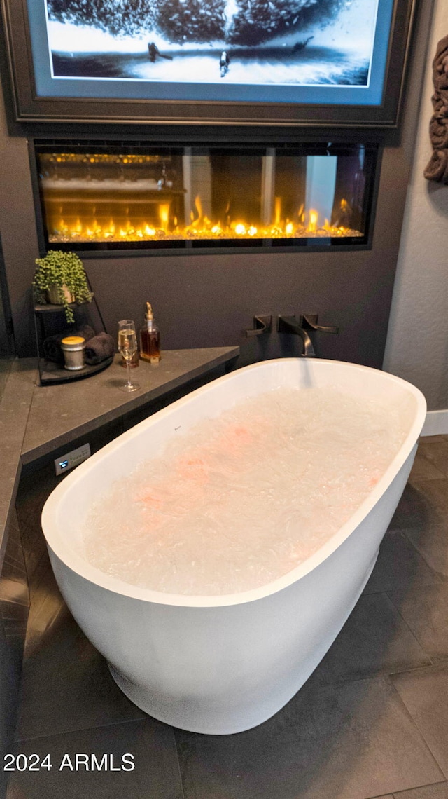 interior space featuring tile patterned floors and a tub to relax in