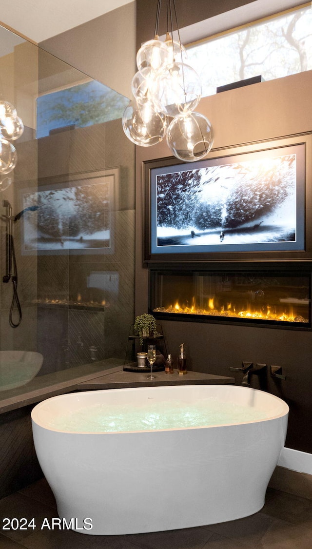 bathroom with a washtub and tile patterned flooring