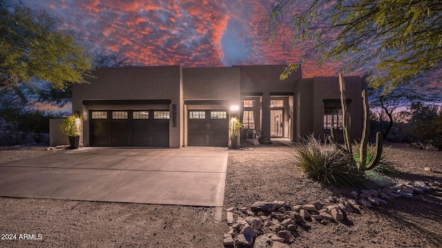 pueblo revival-style home with a garage