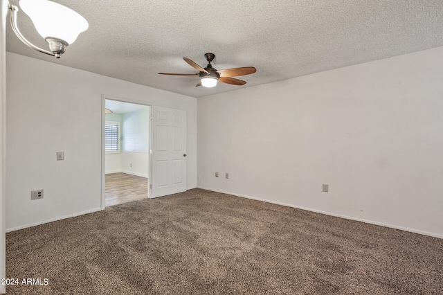 spare room featuring ceiling fan, carpet floors, and a textured ceiling