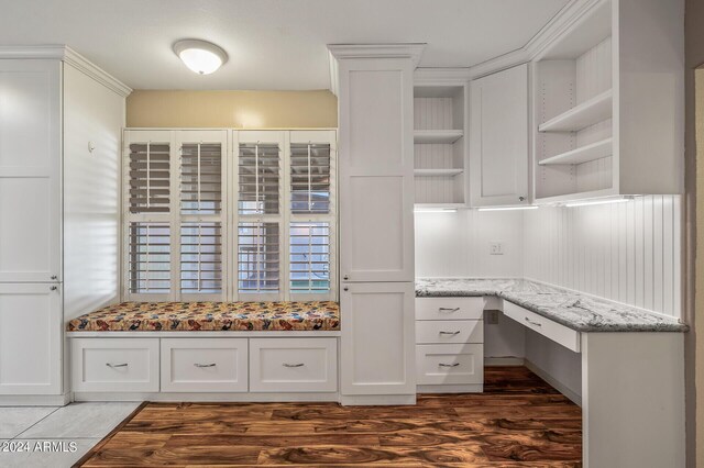 kitchen featuring white cabinets, sink, light stone countertops, and stainless steel appliances