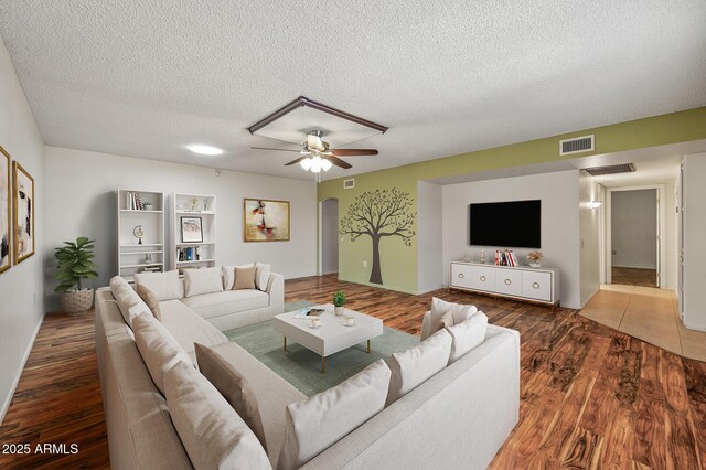 kitchen with light stone counters, white cabinets, light hardwood / wood-style floors, and ceiling fan