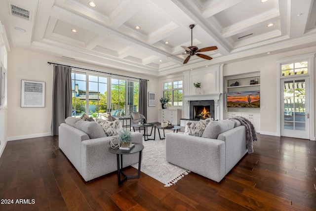 living room with ceiling fan, dark hardwood / wood-style floors, beam ceiling, and coffered ceiling