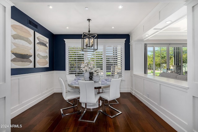 dining room featuring dark hardwood / wood-style flooring and a chandelier