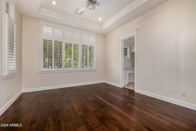 unfurnished room with dark hardwood / wood-style flooring, ceiling fan, a raised ceiling, and crown molding