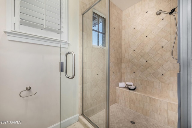 bathroom with a shower with shower door