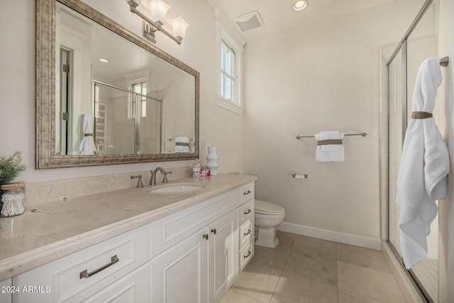 bathroom featuring tile patterned floors, vanity, toilet, and walk in shower