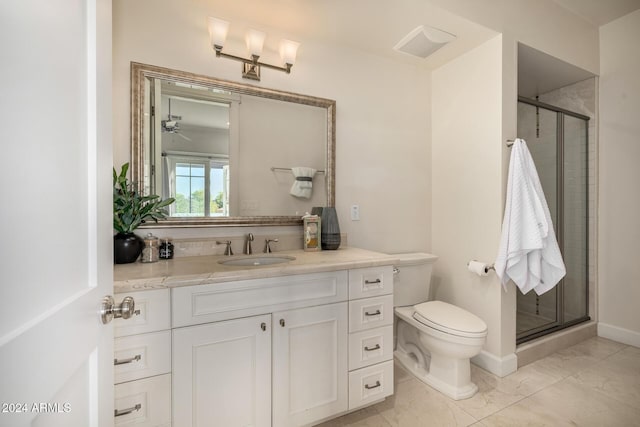 bathroom with ceiling fan, vanity, a shower with shower door, and toilet