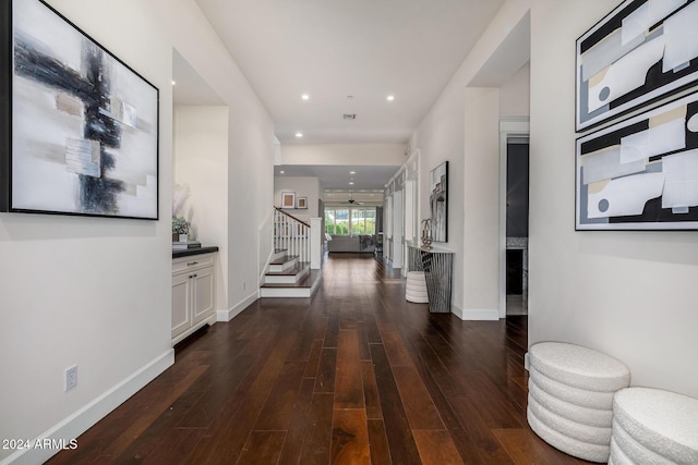 hallway with dark hardwood / wood-style flooring