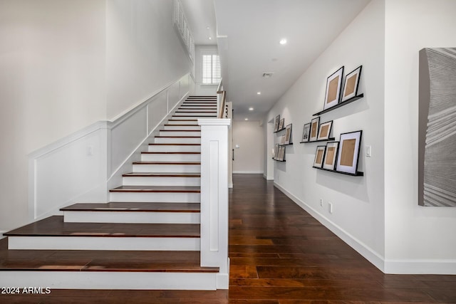 staircase with wood-type flooring