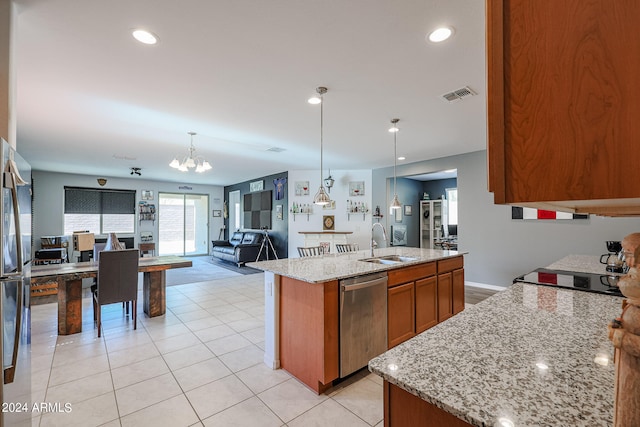 kitchen with an inviting chandelier, decorative light fixtures, a center island with sink, stainless steel dishwasher, and sink