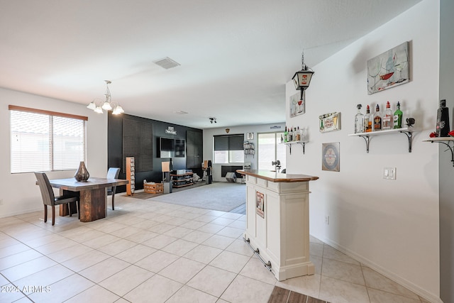 kitchen featuring an inviting chandelier and light tile patterned floors