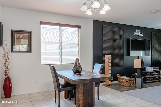 tiled dining area featuring a chandelier