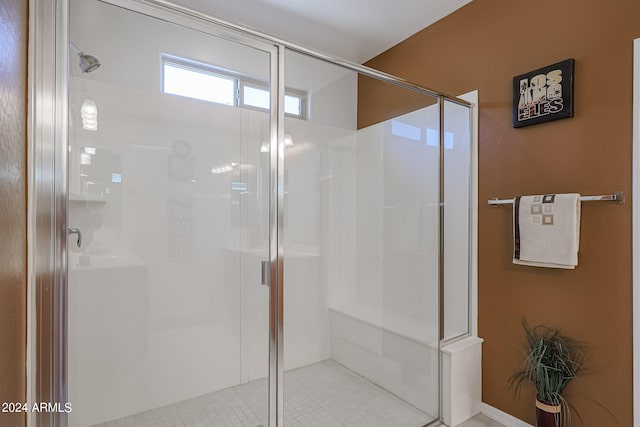 bathroom with tile patterned flooring and a shower with shower door