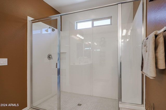 bathroom featuring tile patterned flooring and an enclosed shower