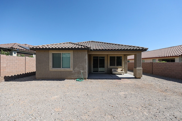 back of house with a patio area