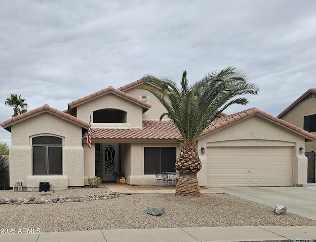 7326 W Dreyfus Dr, Peoria, AZ 85381 - mediterranean / spanish home with a garage, stucco siding, a tiled roof, and driveway