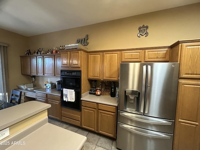 7326 W Dreyfus Dr, Peoria, AZ 85381 - kitchen with stainless steel refrigerator with ice dispenser, light countertops, and brown cabinetry