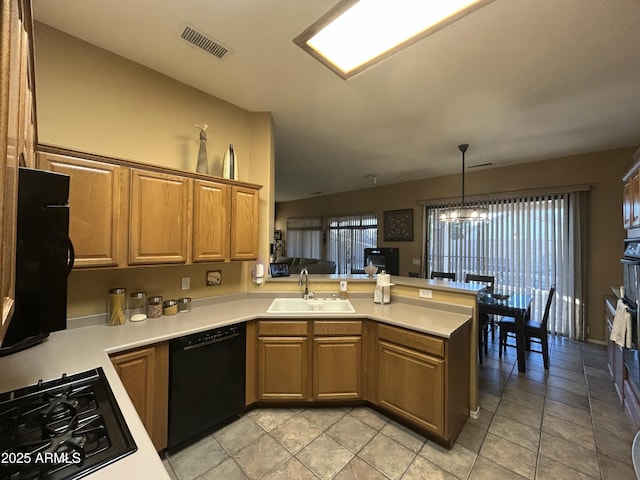 7326 W Dreyfus Dr, Peoria, AZ 85381 - kitchen featuring a sink, black appliances, a peninsula, light countertops, and a chandelier