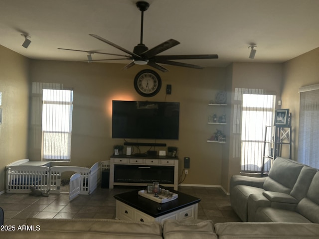7326 W Dreyfus Dr, Peoria, AZ 85381 - tiled living area with a ceiling fan, plenty of natural light, and baseboards
