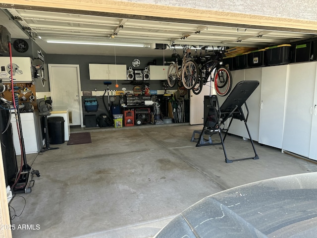 7326 W Dreyfus Dr, Peoria, AZ 85381 - garage with a garage door opener and a workshop area