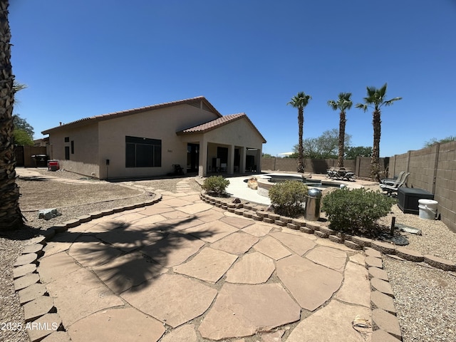 7326 W Dreyfus Dr, Peoria, AZ 85381 - back of property with a fenced backyard, stucco siding, a patio, a tiled roof, and a fire pit